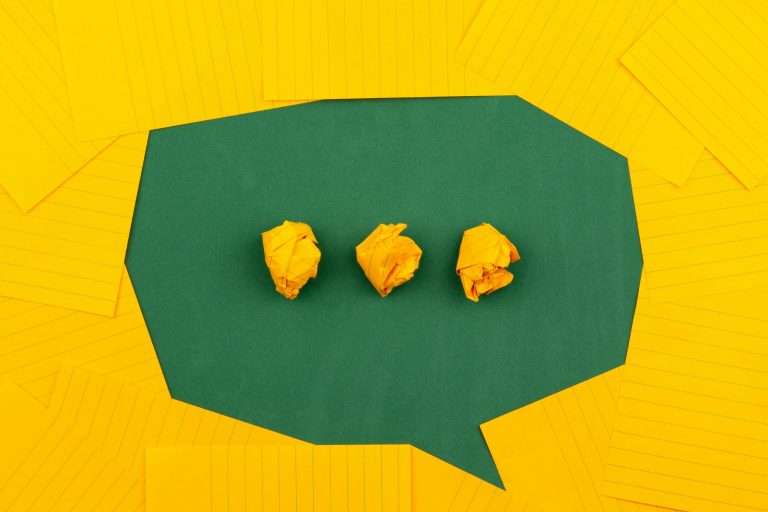 Yellow paper shaped into a universal chat symbol with green background