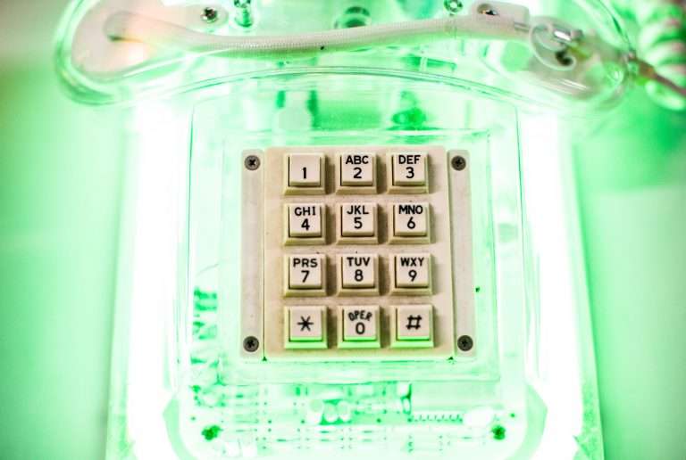 neon green lights with phone keypads sitting on top