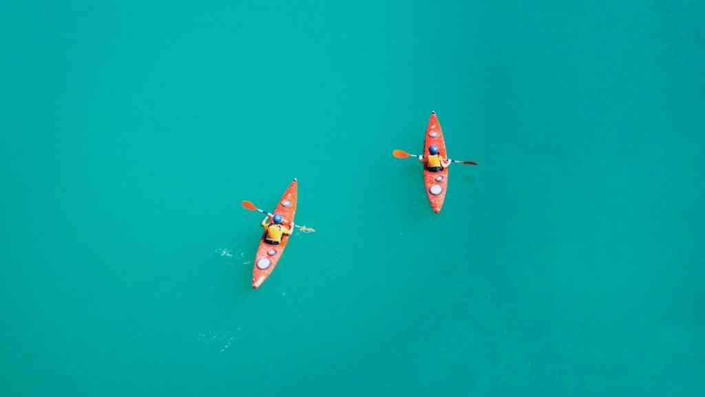 Two kayaks in an open water seen in aerial view.