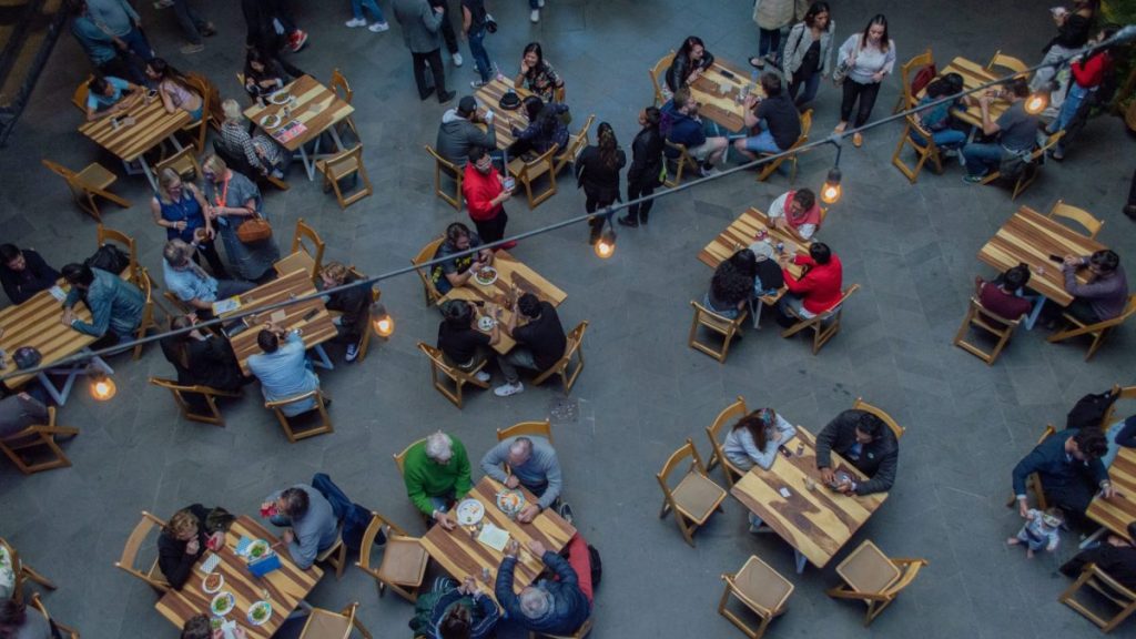 Overhead view of crowds of people sitting at restaurant table