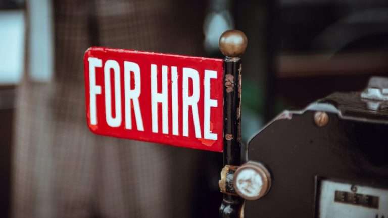 Red "For Hire" sign with white text.