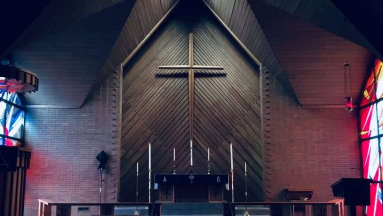 Church alter with cross on the wall.