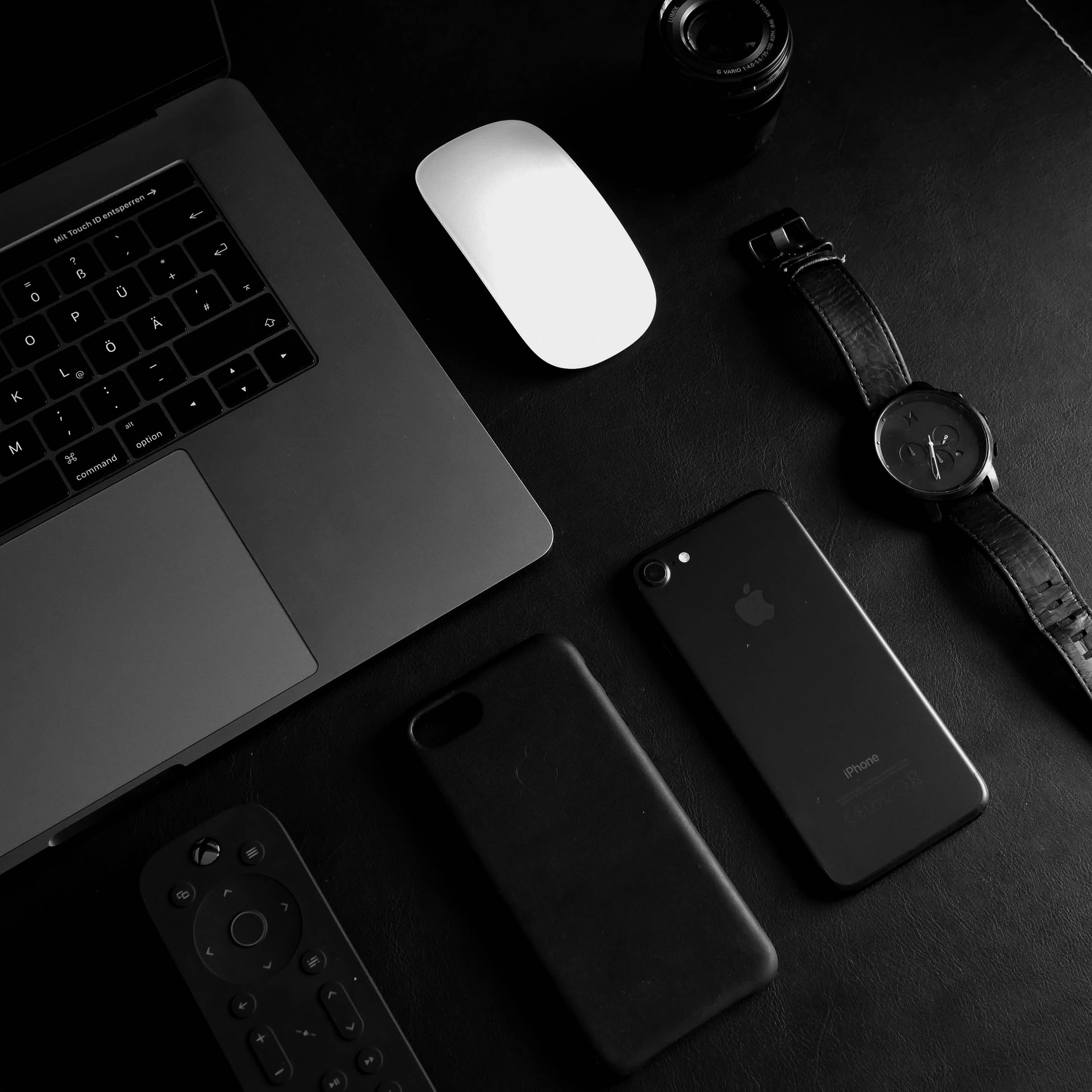 Dark image of laptop mouse smartphone and smartwatch